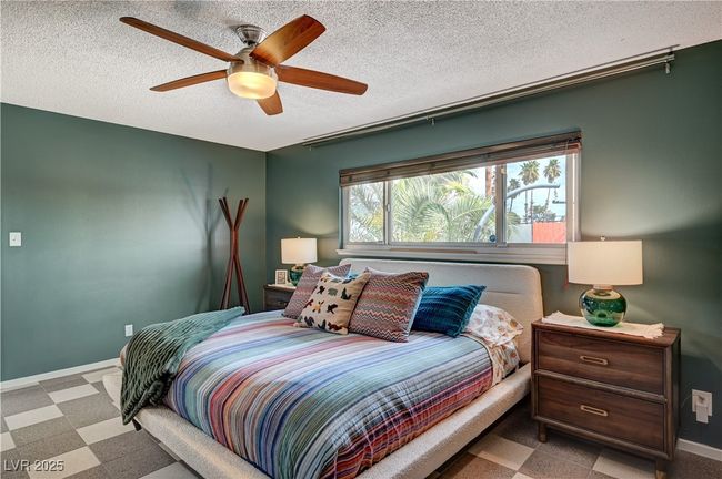 Bedroom with ceiling fan, baseboards, a textured ceiling, and tile patterned floors | Image 24