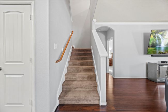 Neutral tones flow throughout the home, offering a refined and timeless designer touch. Soft grey hues pair effortlessly with crisp white trim and rustic wood accents, creating a harmonious blend of warmth and elegance. | Image 23