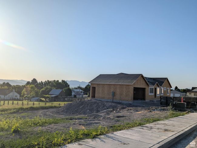 View of property exterior with a garage and a mountain view | Image 7
