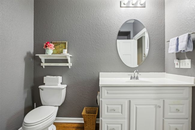 Primary bathroom featuring toilet, wood plank laminate flooring, and vanity | Image 27
