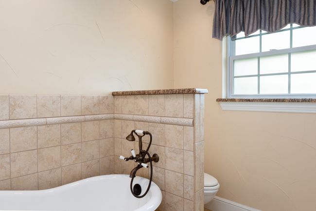Full bath featuring a bath and toilet | Image 36