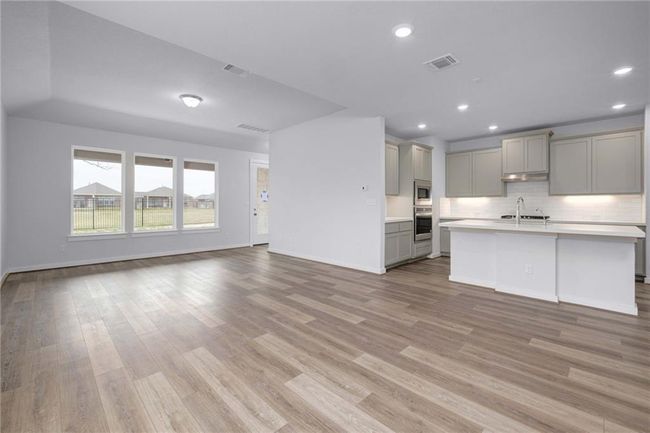 Kitchen with gray cabinetry, open floor plan, light countertops and light wood finished​​‌​​​​‌​​‌‌​‌‌​​​‌‌​​‌‌​‌​​​​​‌ floors | Image 4