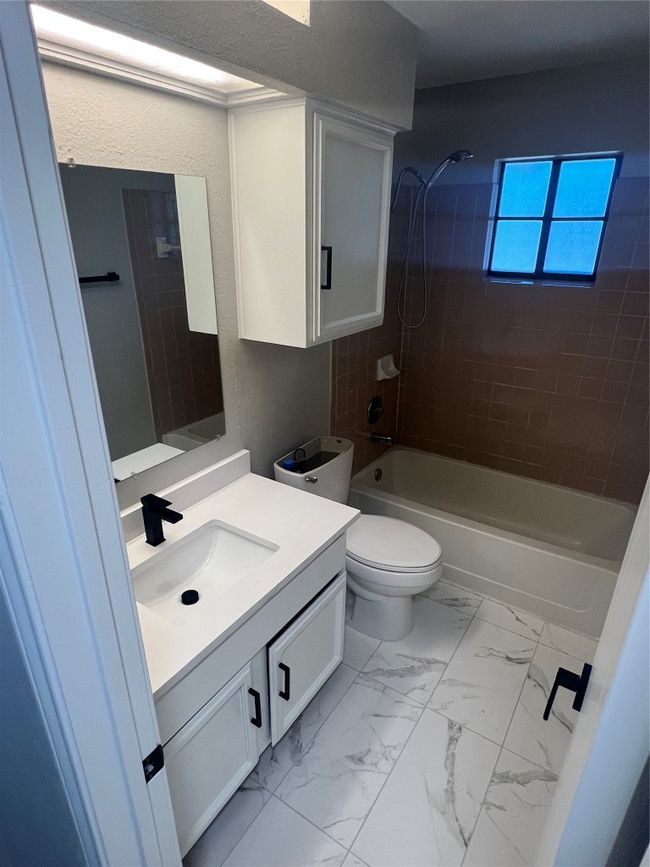 Bathroom with vanity, shower / bath combination, and marble finish floors | Image 20