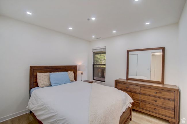 Bedroom with light hardwood / wood-style floors | Image 17