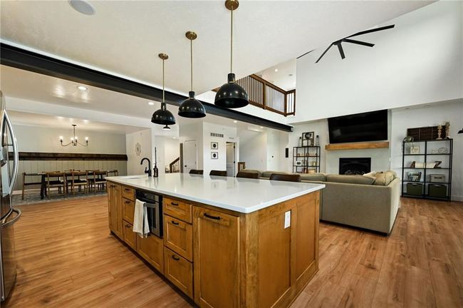 Wood island with quartz counters. | Image 16