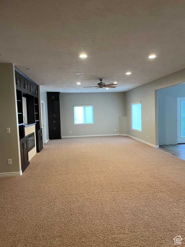 Unfurnished living room with light carpet, a ceiling fan, and recessed lighting | Image 14