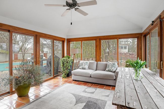 The 4 season porch is adjacent to the pool and patio area. | Image 30