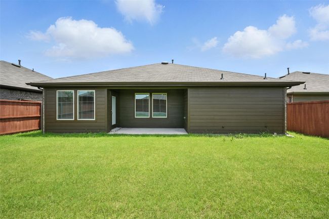 Rear view of house with a fenced backyard and a patio | Image 20