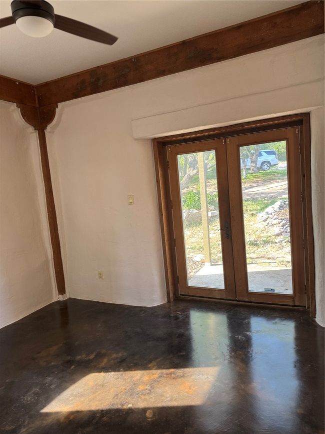 Empty room with finished concrete flooring and french doors | Image 38
