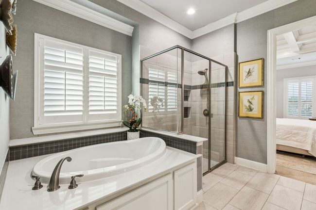 Large garden tub and extended glass framed shower | Image 25