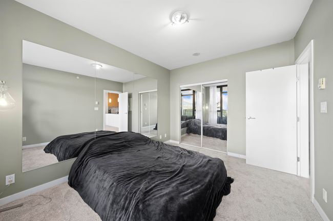 Bedroom with light colored carpet, baseboards, and ensuite bath | Image 16