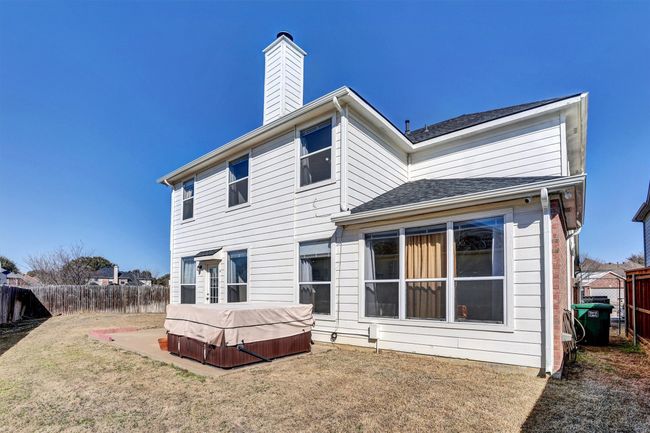 Back of property with a patio, fence, a lawn, a chimney, and a hot tub | Image 4