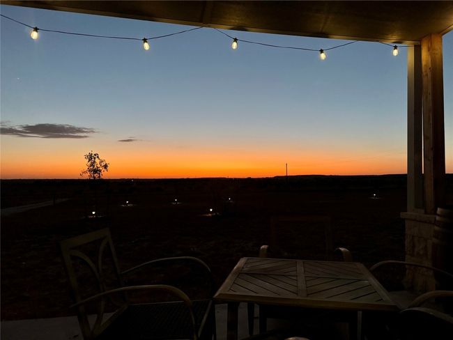 Patio terrace at dusk featuring outdoor dining area | Image 38