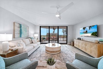 Living room featuring wood-type flooring and ceiling fan | Image 2