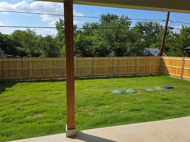 View of yard with wood fence. | Image 12