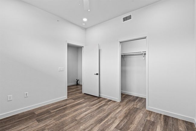 Unfurnished bedroom with wood finished floors, baseboards, a closet, recessed lighting, and a ceiling fan | Image 11