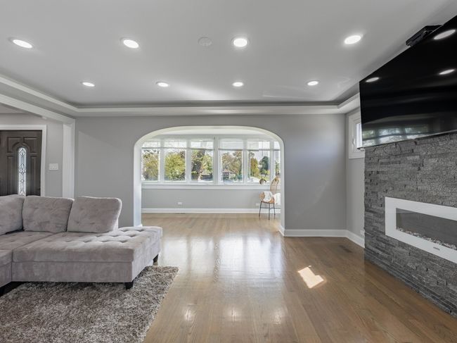 Sun-drenched living room with gleaming hardwood fl | Image 11