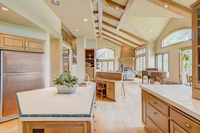 Pigeon holes and a file drawer help to organize all of the daily clutter, along with storage for your cooking library with open bookshelves | Image 15