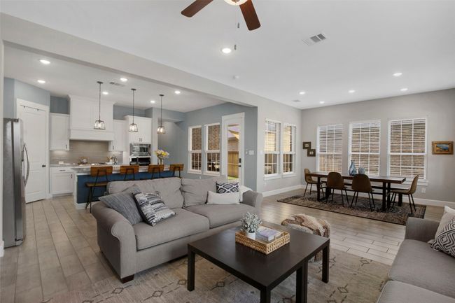 Living area featuring wood finish floors, ceiling fan, recessed lighting, and baseboards | Image 6