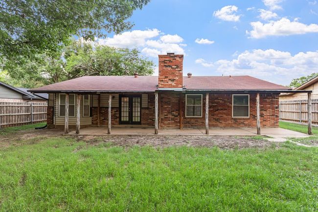 Back of house featuring a patio, a chimney, french doors, and brick siding | Image 29