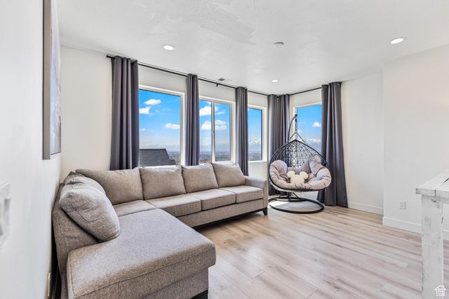 Living room with baseboards, light wood-type flooring, and recessed lighting | Image 46