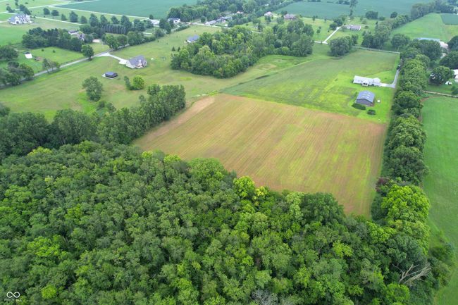aerial view of sparsely populated area featuring farmland | Image 11