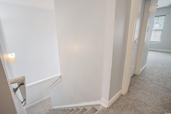 Corridor featuring carpet flooring and an upstairs landing | Image 9