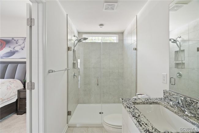 Ensuite bathroom with a stall shower, toilet, ensuite bath, and visible vents | Image 20