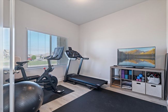 Exercise area with wood finished floors and baseboards | Image 4