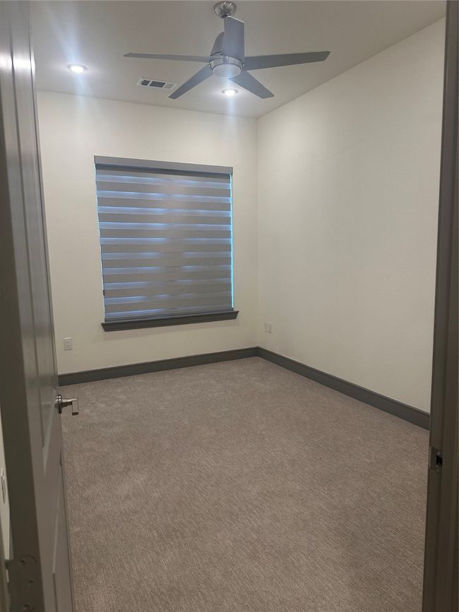 Unfurnished room with a ceiling fan and carpet | Image 7
