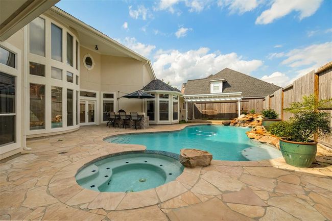 This backyard was made for Houston summers. The sparkling, heated pool with spa offers a refreshing retreat from the heat, while the spacious patio invites lounging in the shade or hosting weekend gatherings. | Image 43