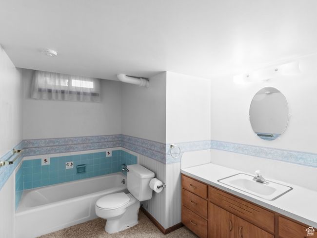Bathroom with a garden tub, toilet, vanity, and a wainscoted wall | Image 24