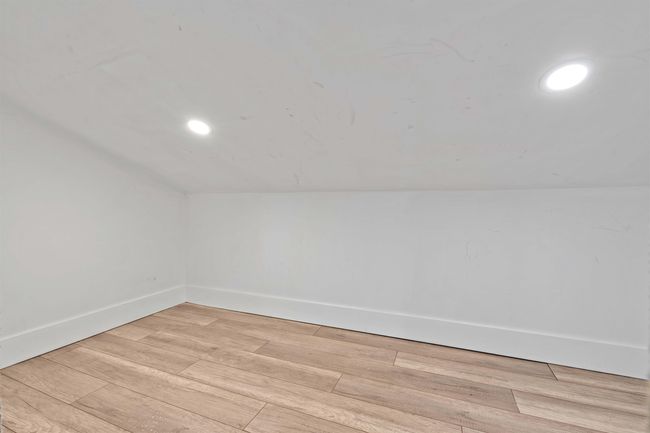 Interior space with light wood-style flooring, baseboards, recessed lighting, and vaulted ceiling | Image 23