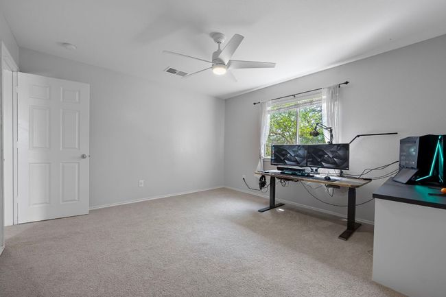 Home office featuring a ceiling fan, carpet floors, and baseboards | Image 26
