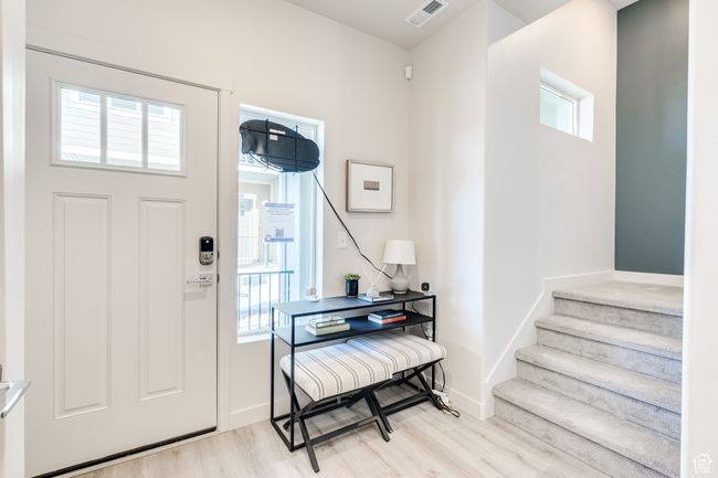 Foyer with light wood-style flooring, stairs, and baseboards | Image 22