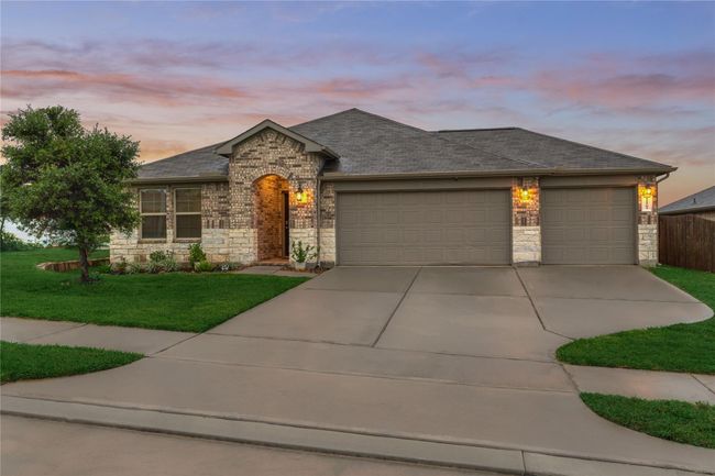 3-car garage and an extra wide driveway for parking. | Image 4