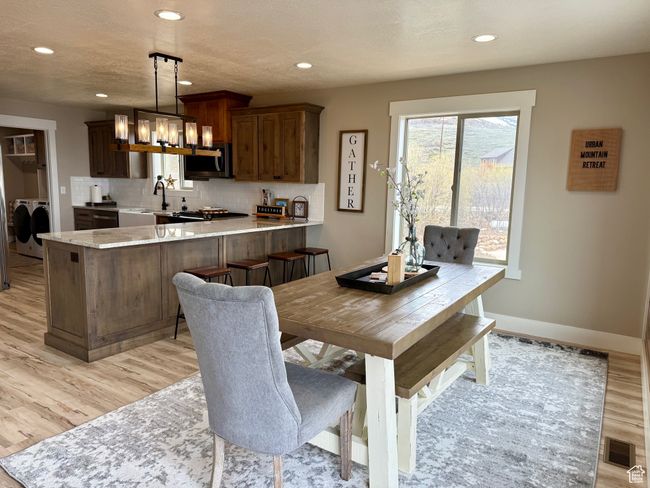 Dining space with recessed lighting, an inviting chandelier, and light wood-type flooring | Image 20