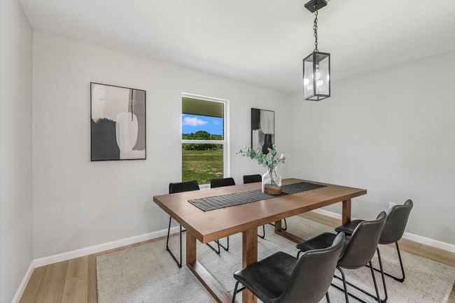 Dining area featuring light wood-style floors and baseboards | Image 7