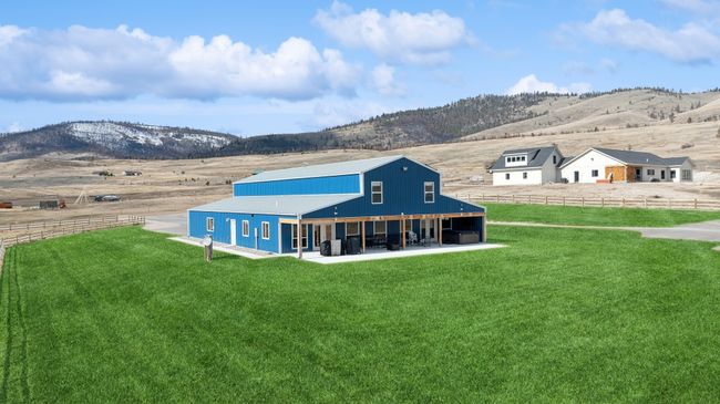 Back of house with a yard, a rural view, and a mountain view | Image 57