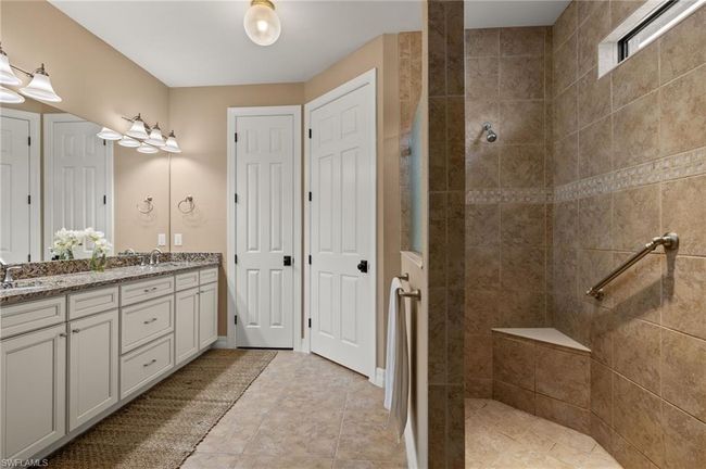 Bathroom featuring vanity and tiled shower | Image 22