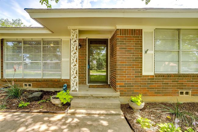 View of exterior entry with brick siding | Image 7