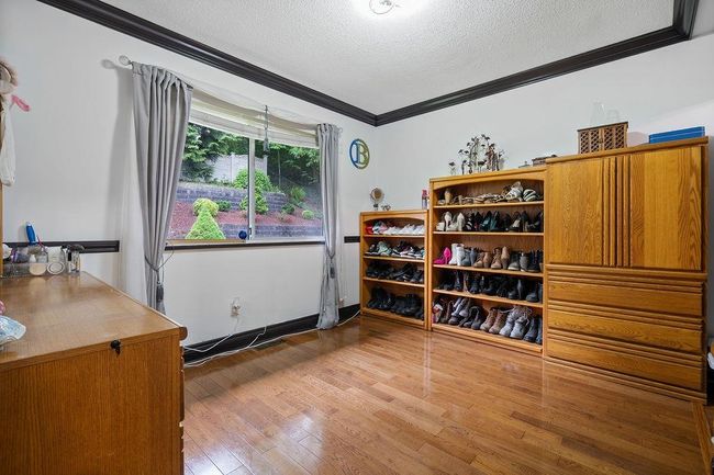 Interior space with a textured ceiling, ornamental molding, and hardwood / wood-style floors | Image 23