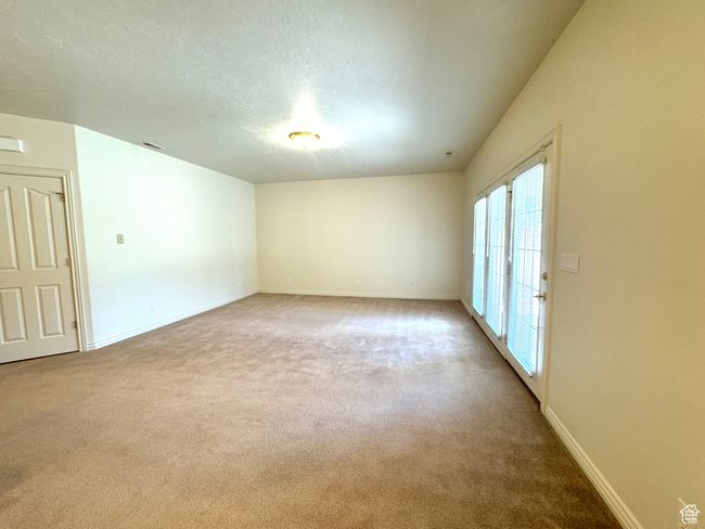 Family room with high ceiling and walkout to patio. | Image 24