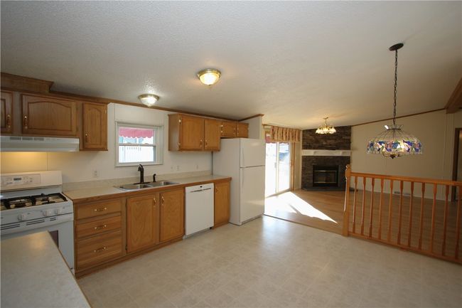Plenty of Room for All the Chefs to prepare meals in this Big Kitchen Cathedral Ceilings run along middle of home allowing for an Open & Spacious Living Space everywhere! (Including extra tall bedroom closets) | Image 21