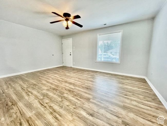 Empty room featuring ceiling fan, baseboards, visible vents, and wood finished floors | Image 5