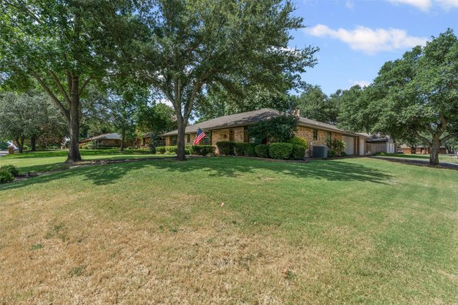 View of grassy yard with a garage | Image 4
