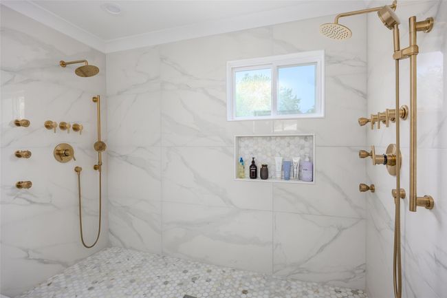 Full bathroom with a marble finish shower and crown molding | Image 24