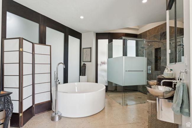 Full bathroom with a shower stall, a freestanding bath, recessed lighting, speckled floor, and a sink | Image 19