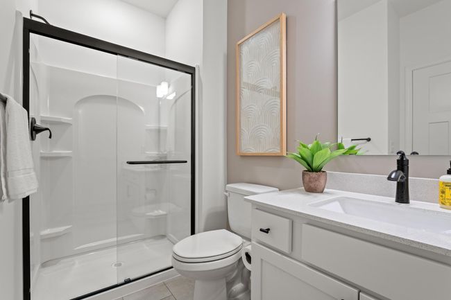 (Photo of a decorated model, actual homes finishes will vary) One of the secondary bedrooms has an en-suite bath. | Image 21