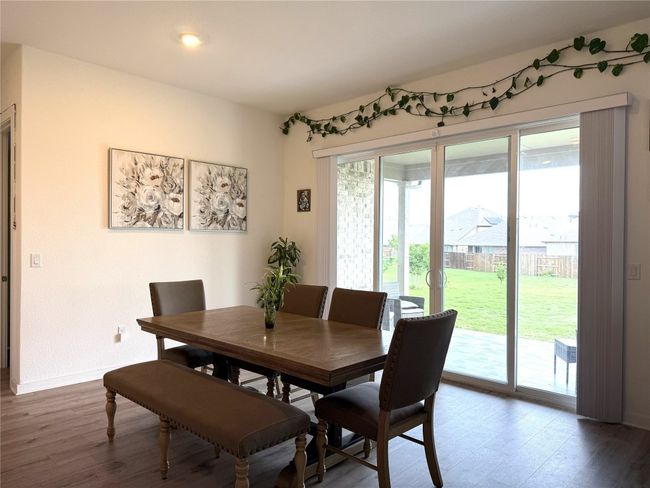 Dining area with wood finished floors and baseboards | Image 7